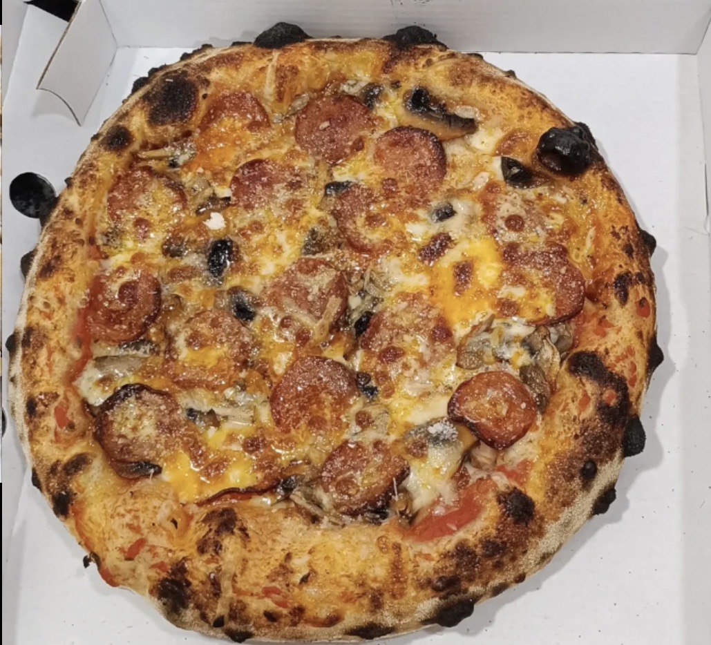 Pizza margherita recién salida del horno de leña